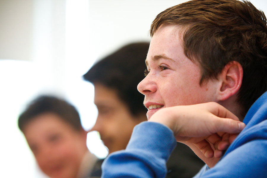 Kids listening to a book being read by the teacher